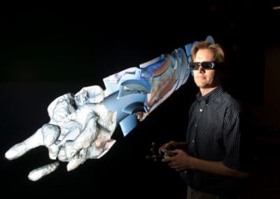 man with VR glasses in front of a virtualization display