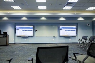 classroom with chairs off to side and two large video wall displays