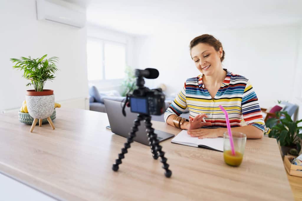 Beautiful caucasian woman recording her video tutorial at home.
