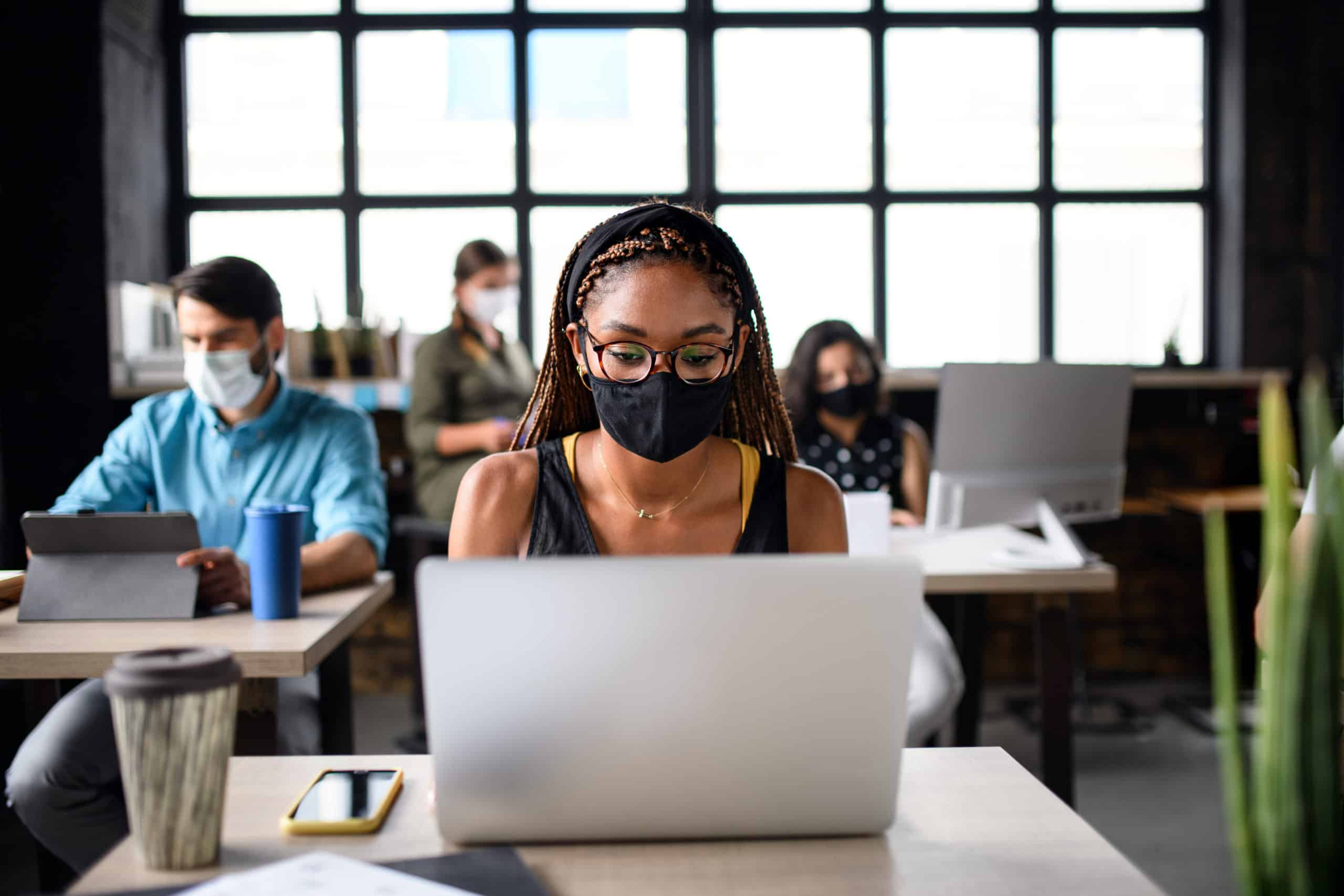 woman working in office wearing mask