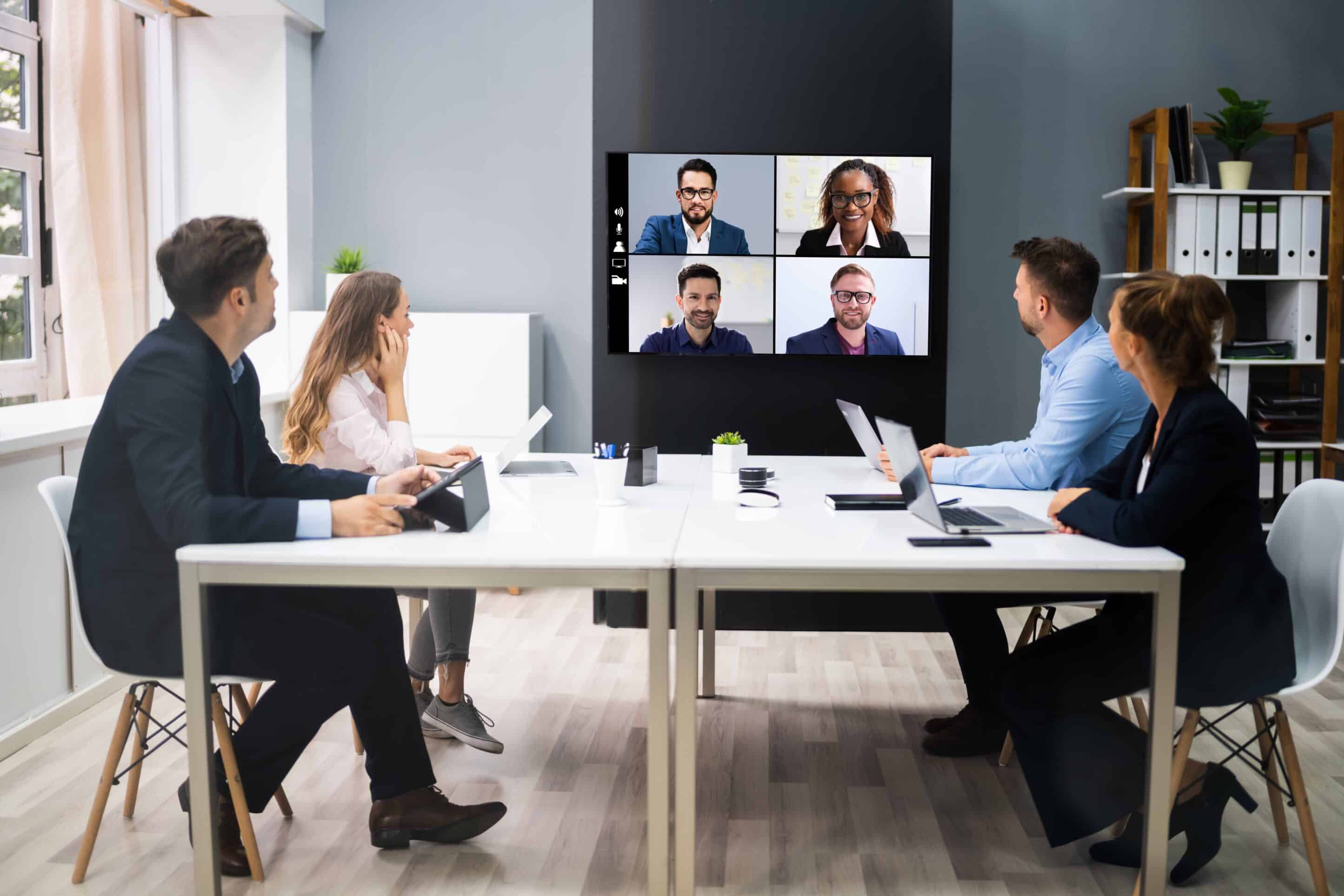 hybrid meeting hacks being used in conference room with on-site and remote participants