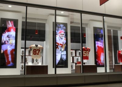 Portrait video displays of Kansas City Chiefs players featured in museum wall