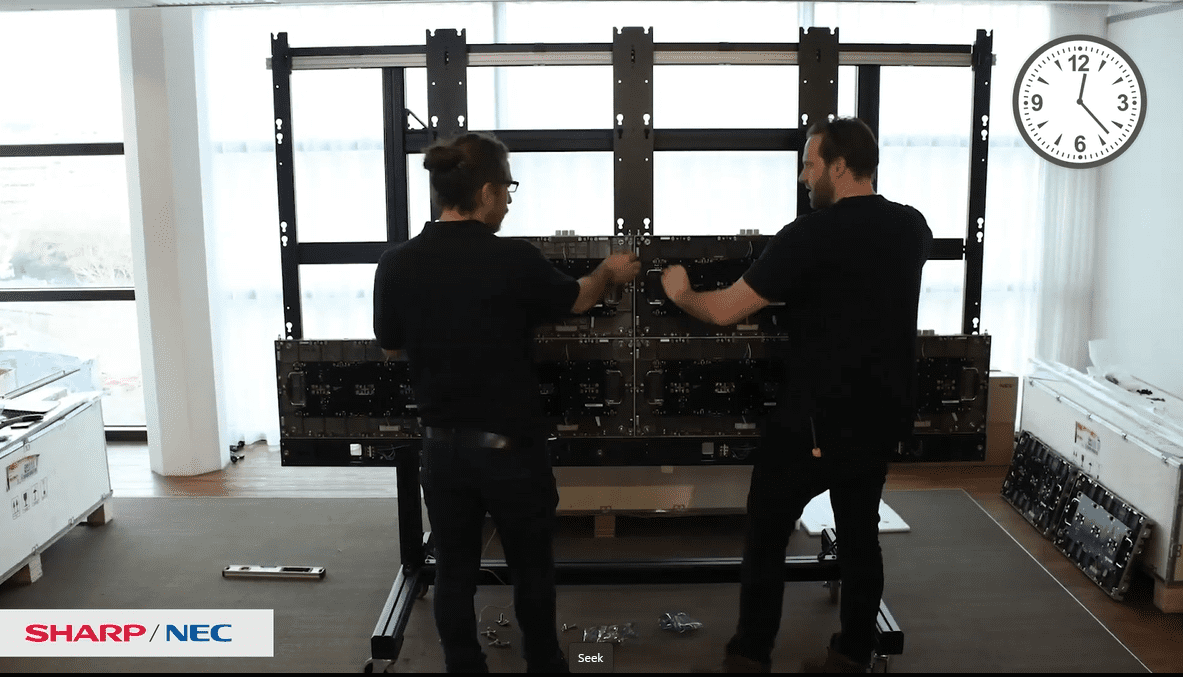 two people installing Sharp nec dvLED video wall kit