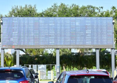 exterior video wall with flight information in parking lot