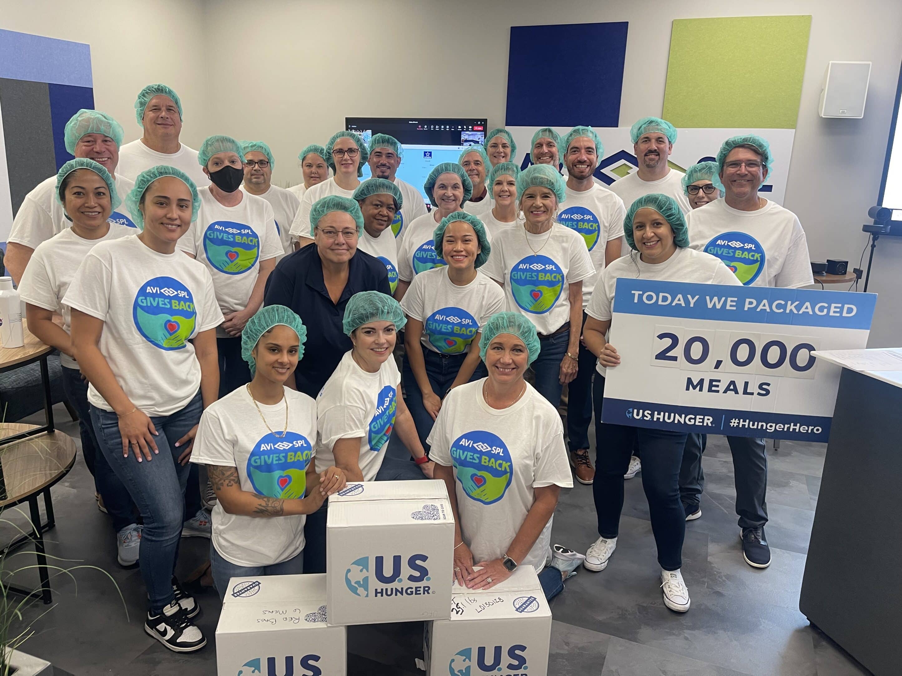 Tampa AVI-SPL employees celebrating packing 20,000 meals for the community