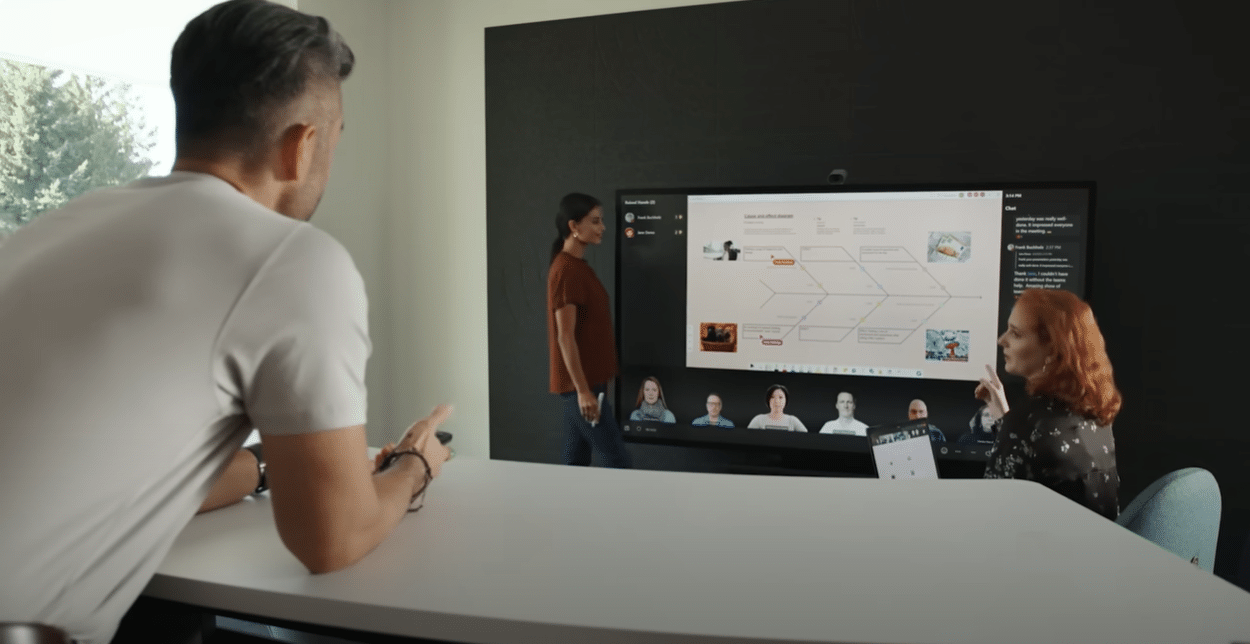 three people using Microsoft Surface Hub 3 in meeting room