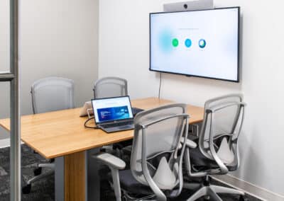 LG huddle space with laptop and wall-mounted digital display