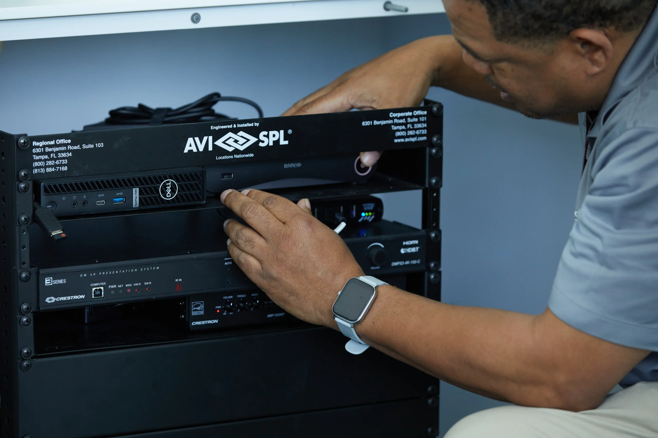 AVI-SPL technician adjusting audio visual equipment