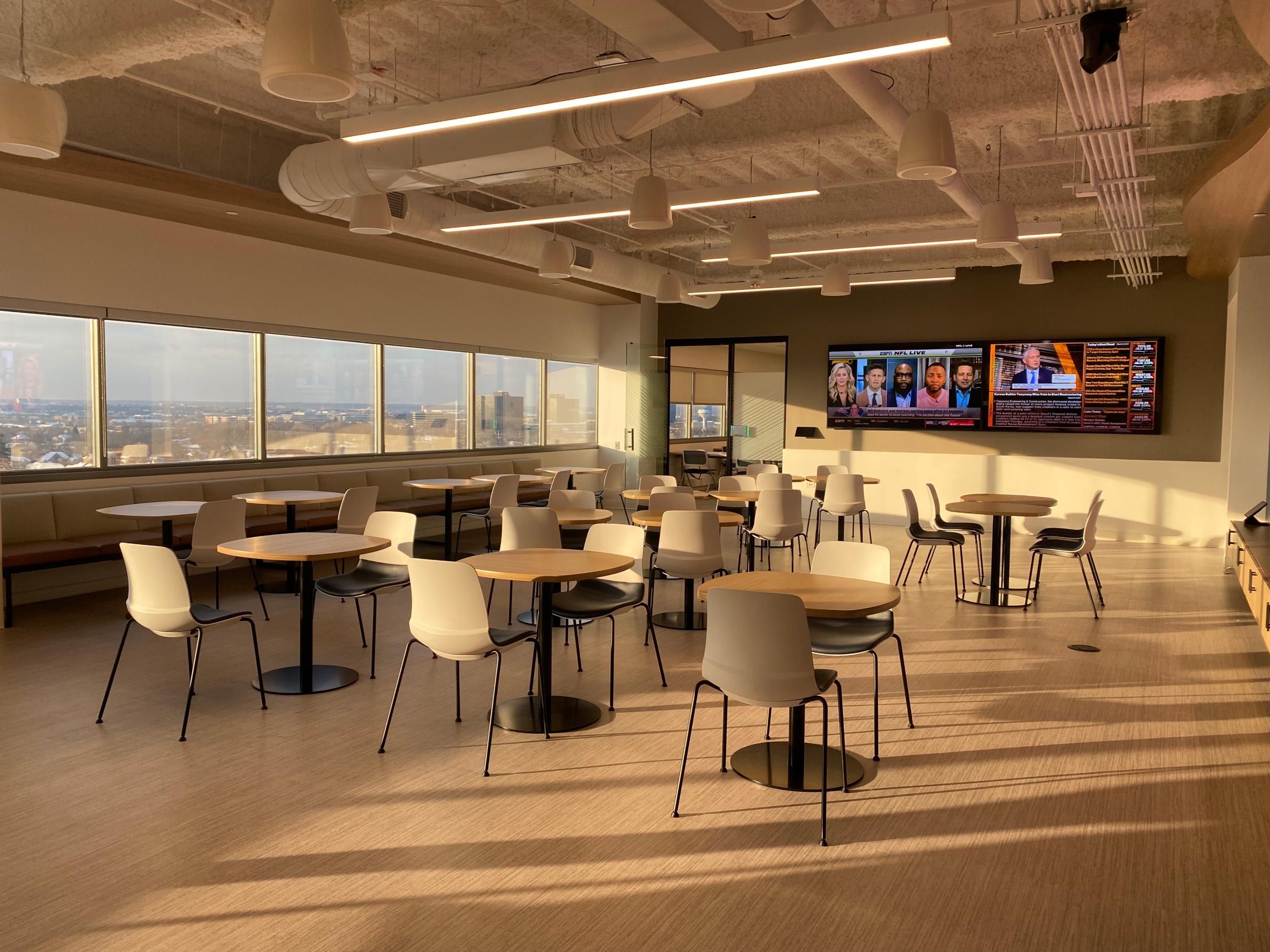 hospitality space with tables and digital signage