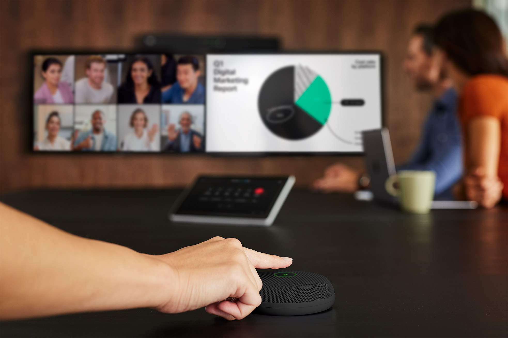 A person adjusts a speakerphone on a table; a screen shows a videoconference with participants and a Digital Marketing Report.