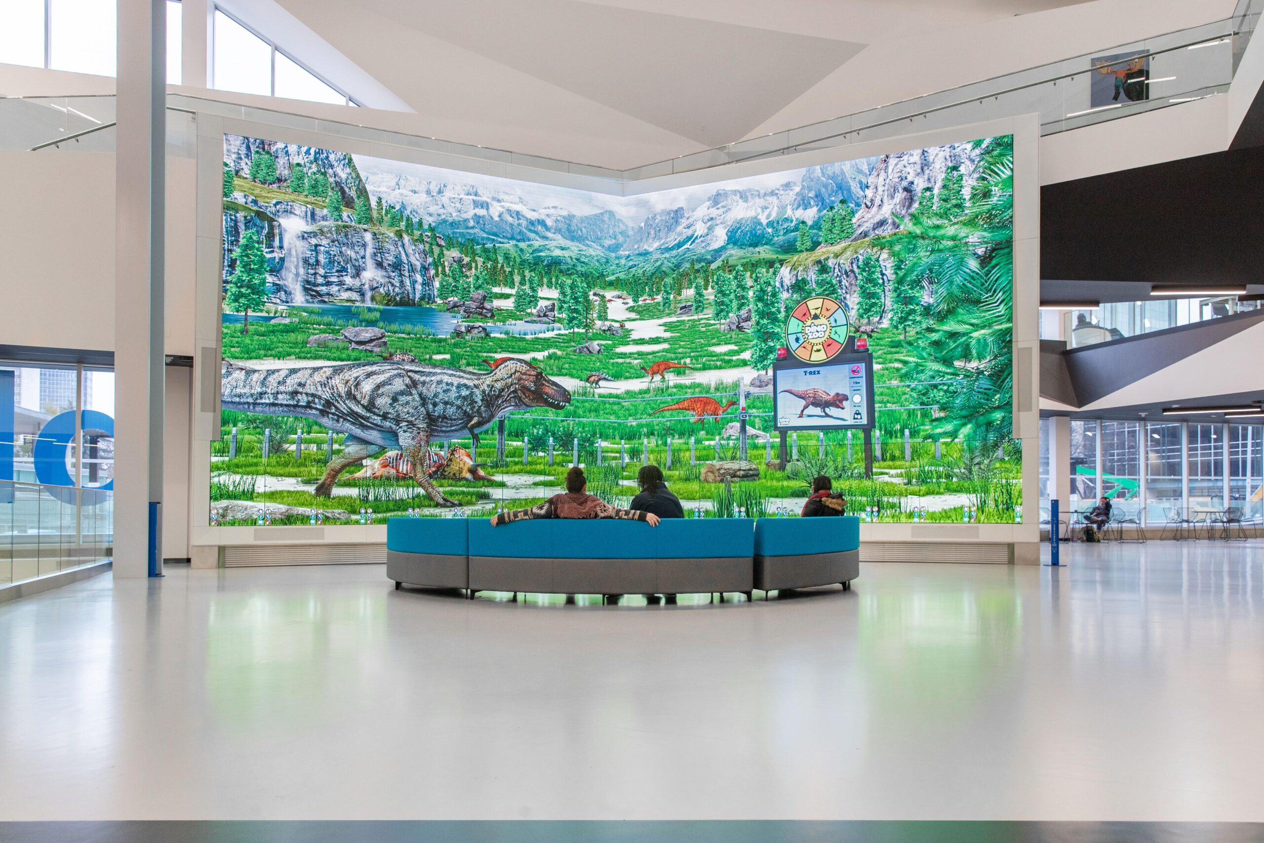 People in front of video wall at a museum