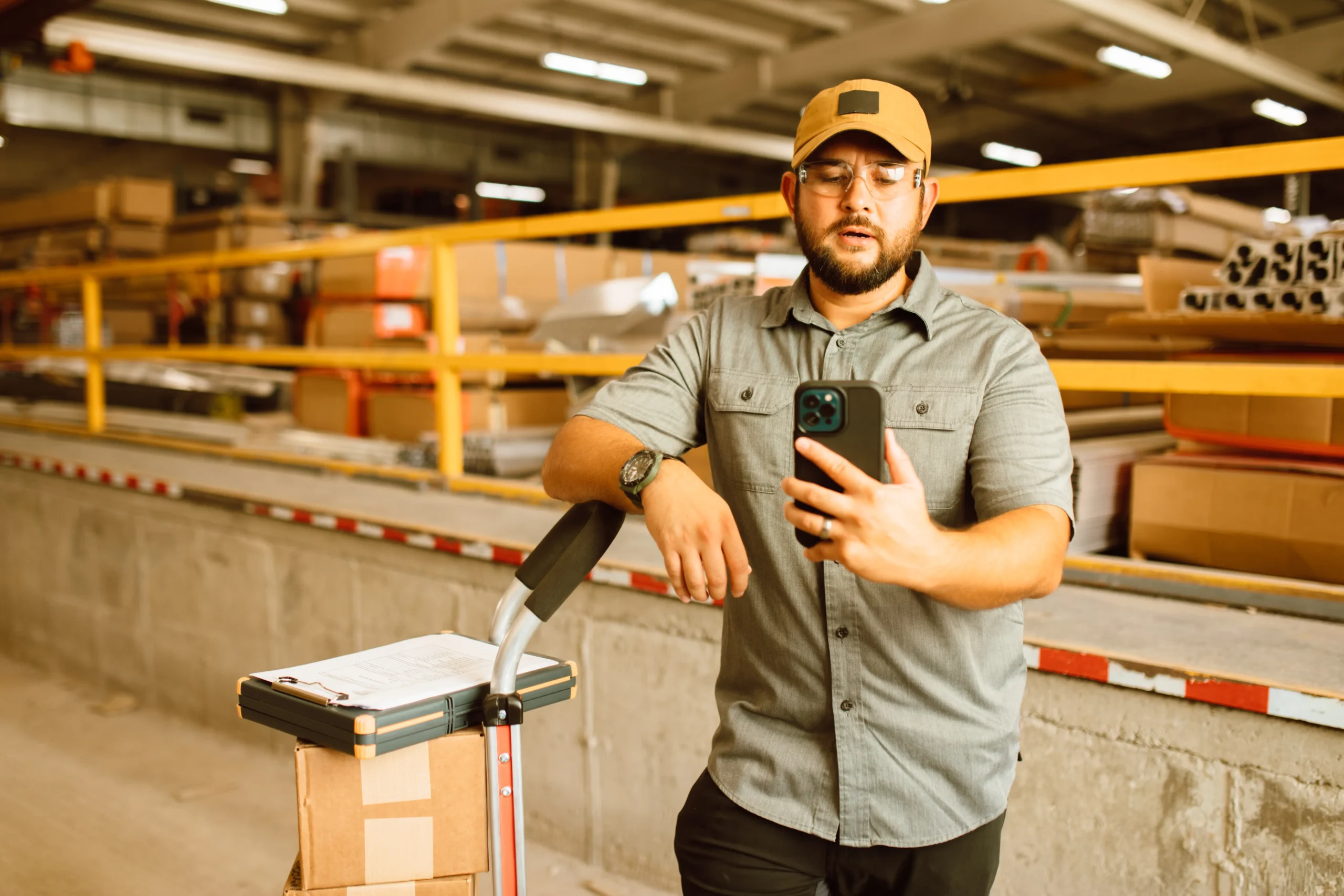 manufacturing supervisor checking production status on mobile phone