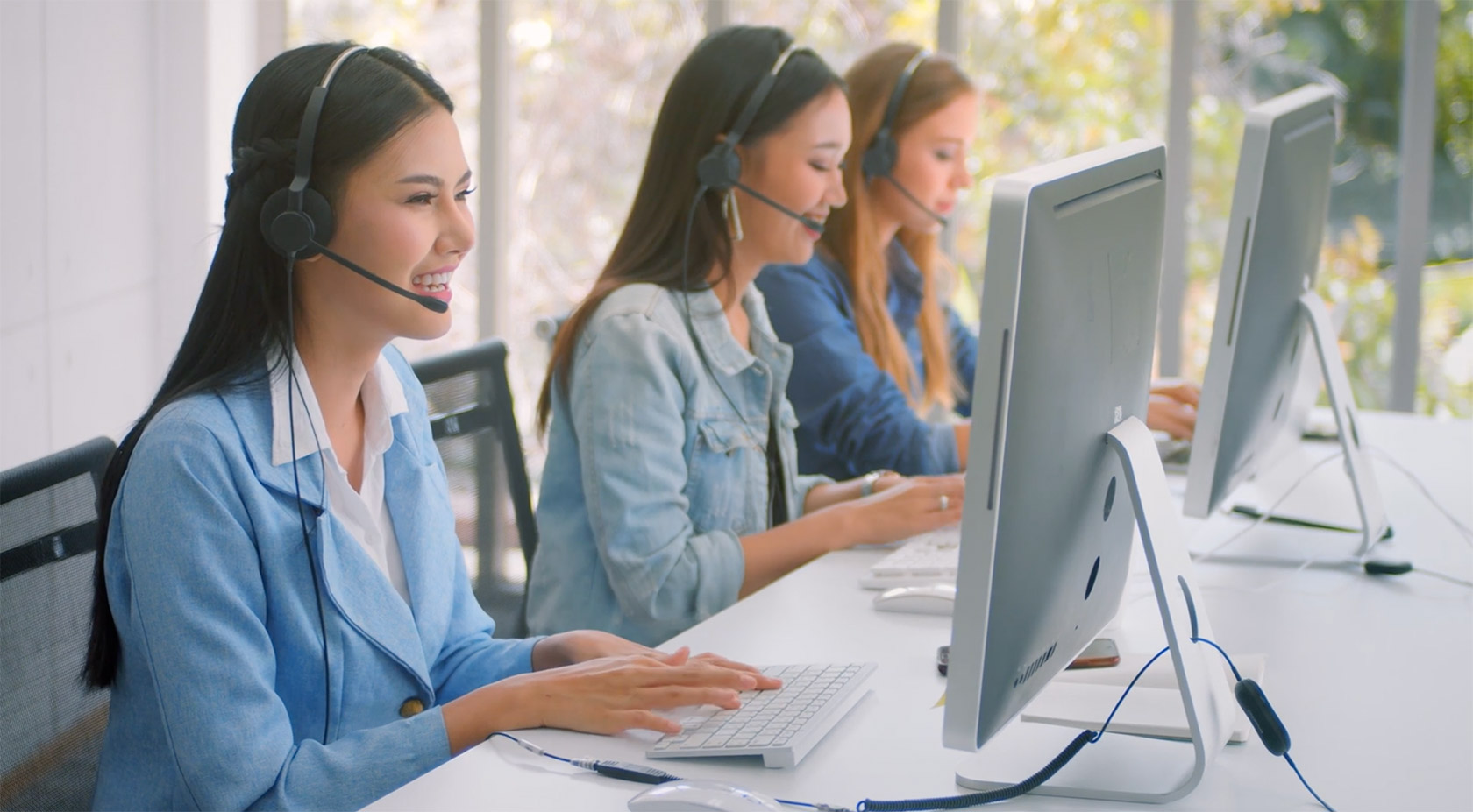 3 Women on their headsets showing how Avaya helps with customer experience