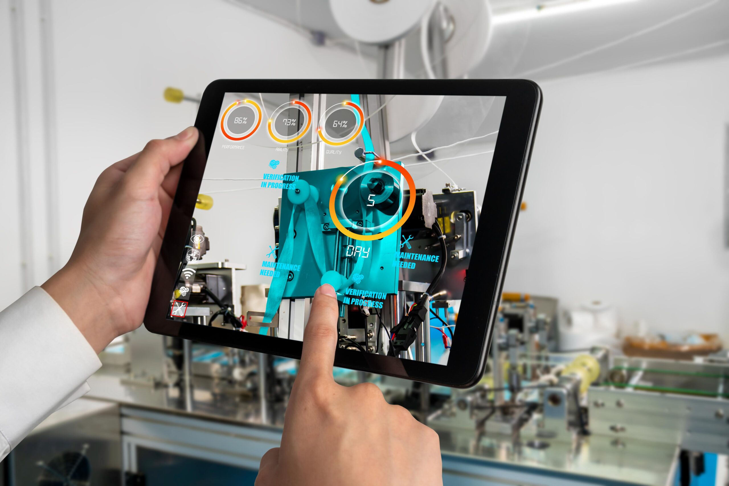 Person uses tablet for AR display of machinery, showing data/controls like temperature/settings in a modern industrial environment.