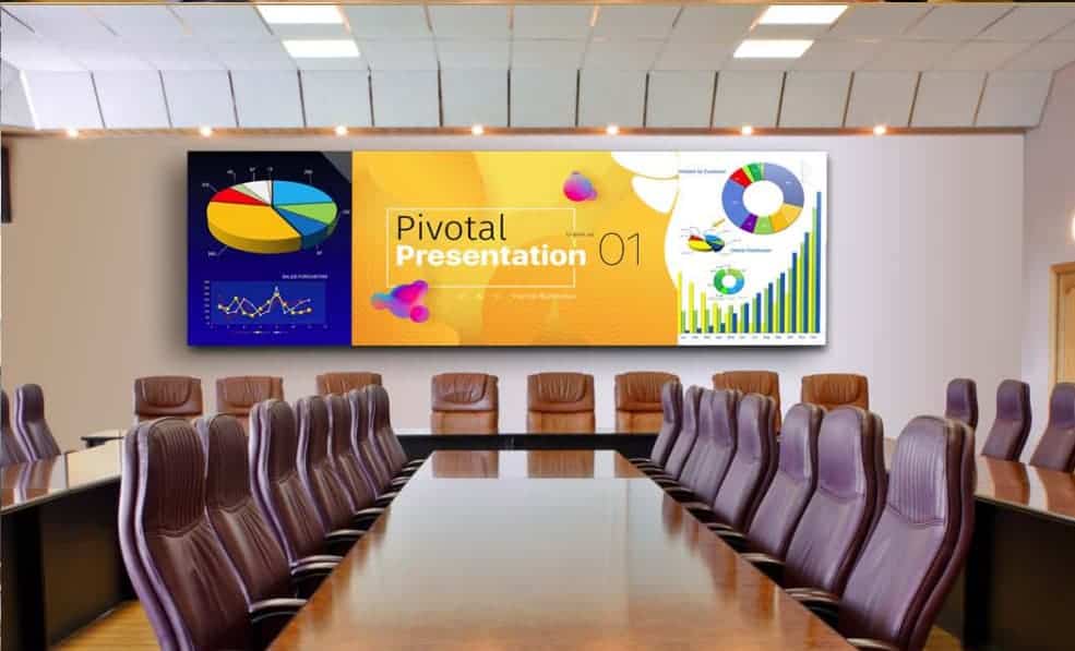 Conference room with long table, brown chairs, large screen titled Pivotal Presentation 01 displaying colorful charts and graphs.