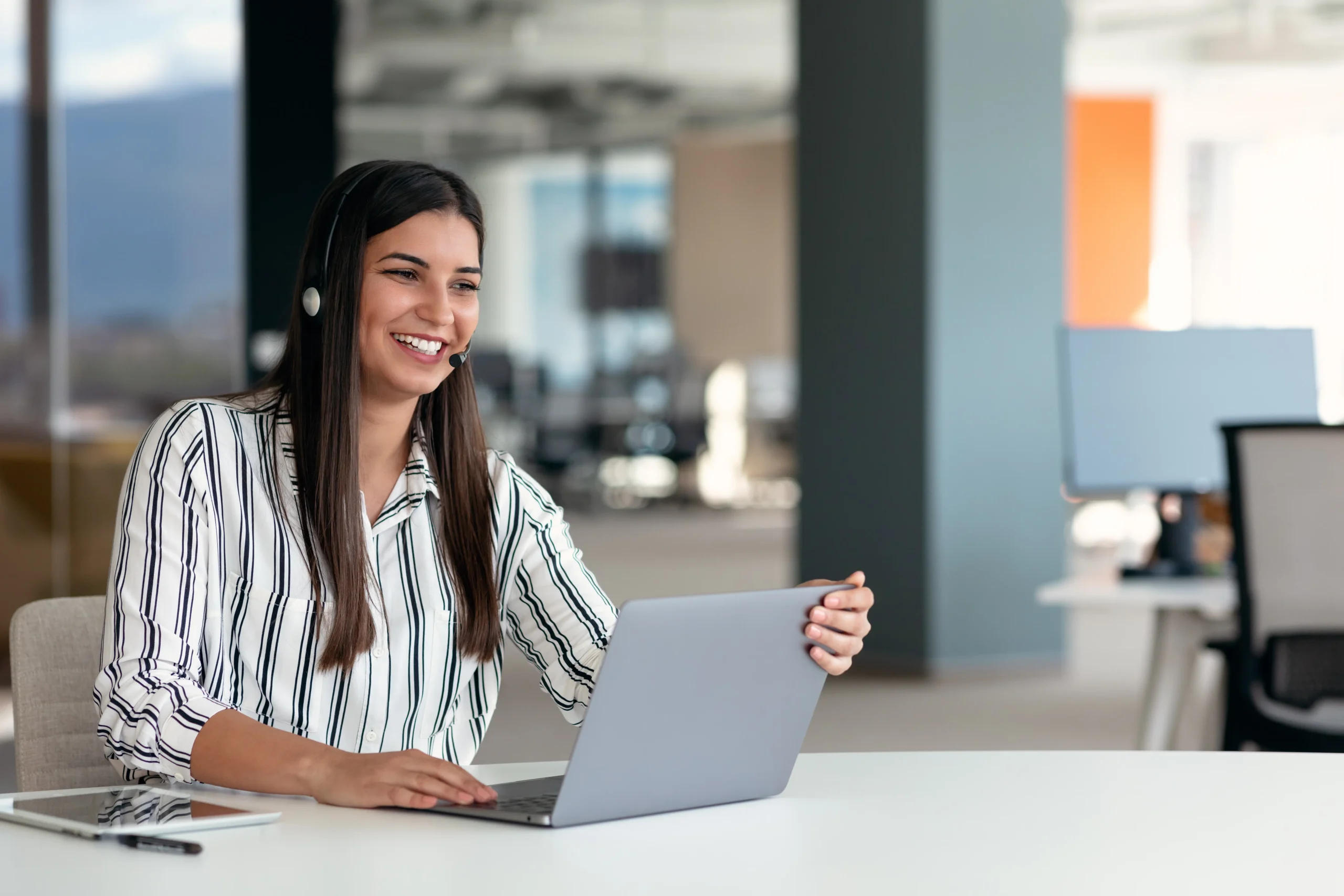 woman using laptop and headset in the office