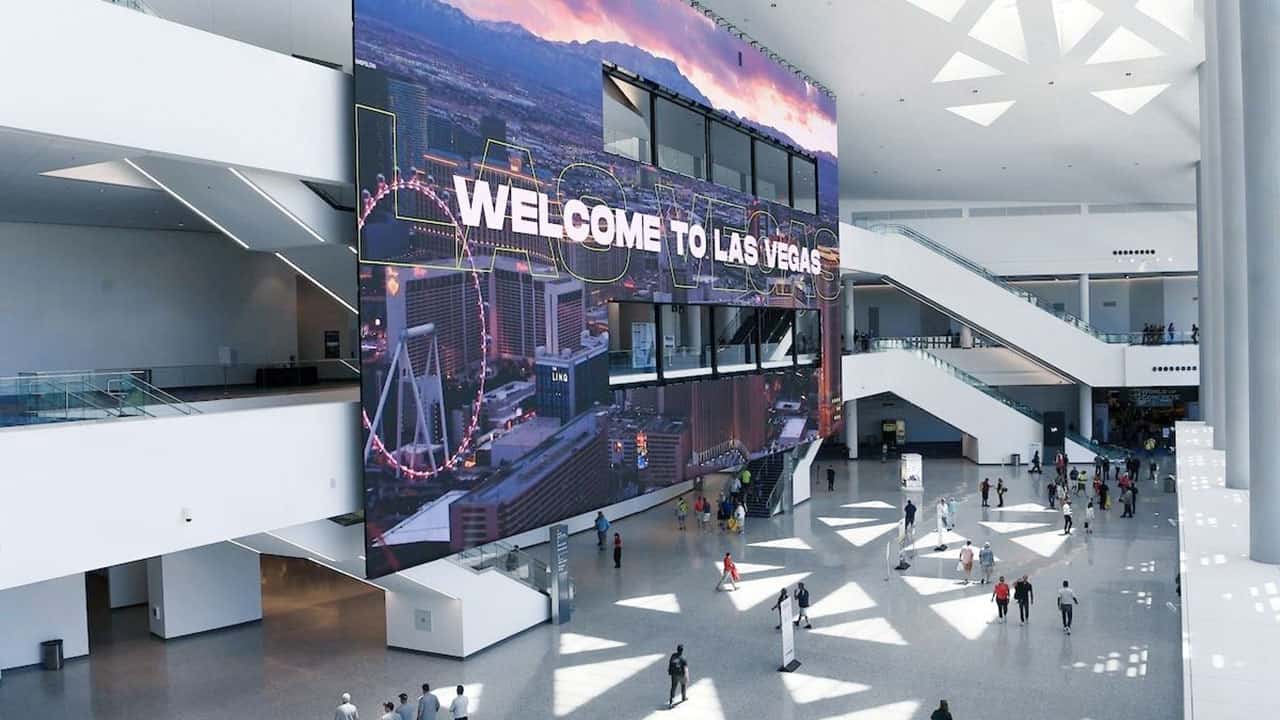 Modern lobby with a digital Welcome to Las Vegas, skyline images, polished floors, white walls, and architectural details.