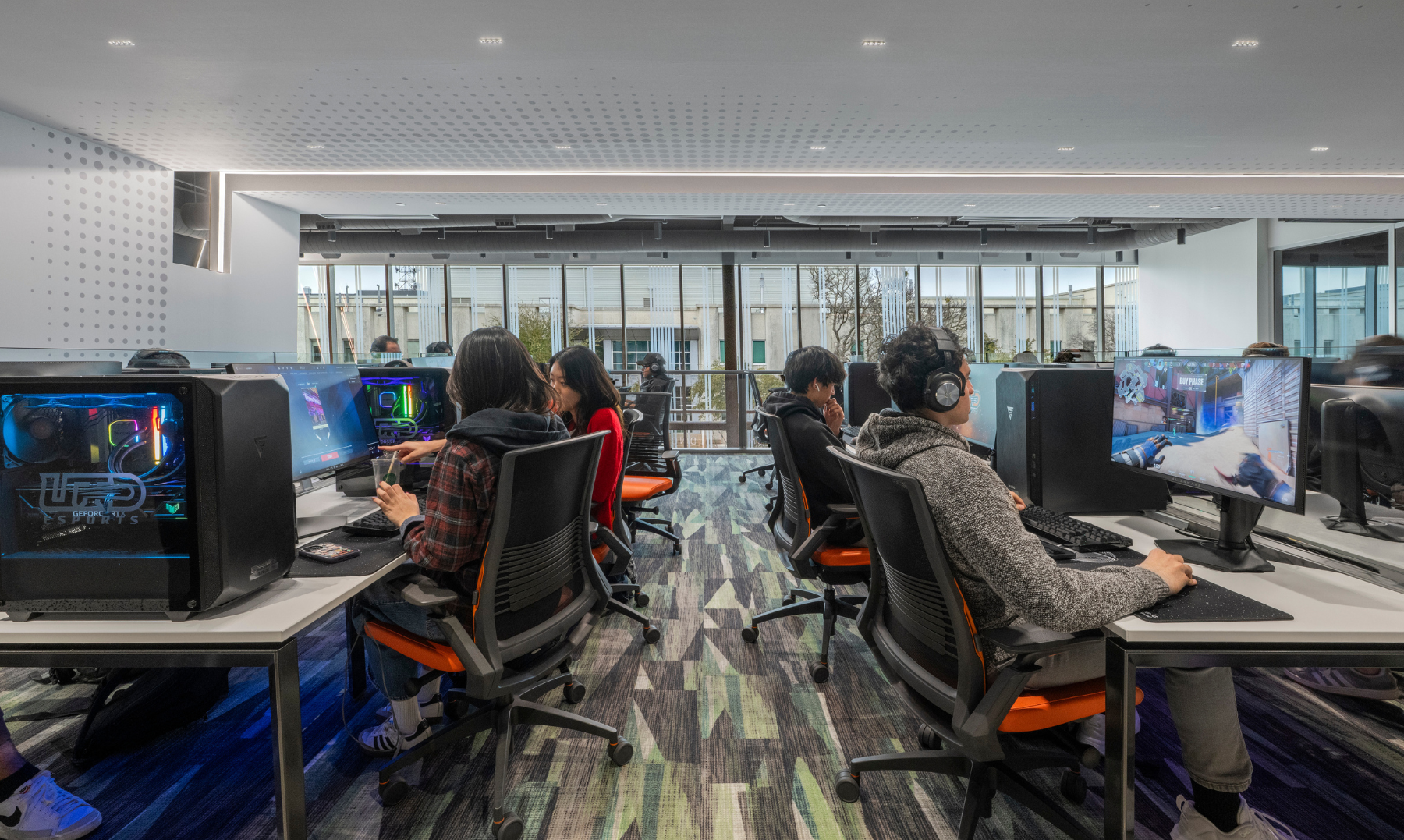 Students at gaming stations on the second floor of Comets LANding Credit - SMITHGROUP