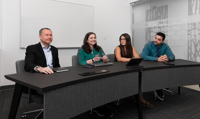 Three people collaborating in a Signature Microsoft Teams Room