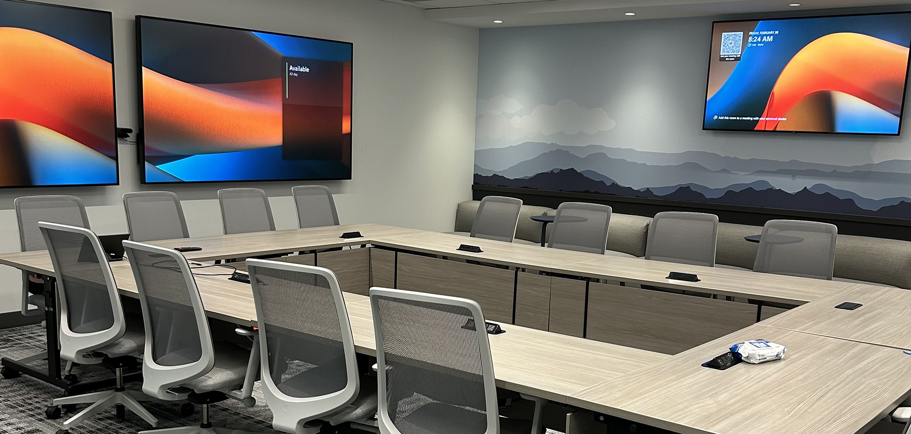 Large IDRC conference room featuring Microsoft Places room scheduling functionality on displays.