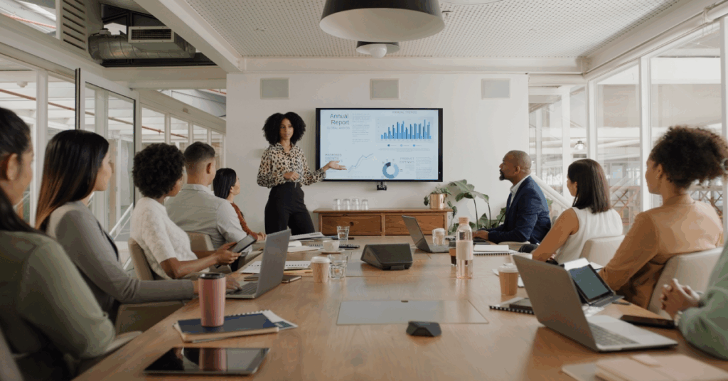 Lady leads an annual report meeting in a conference room.