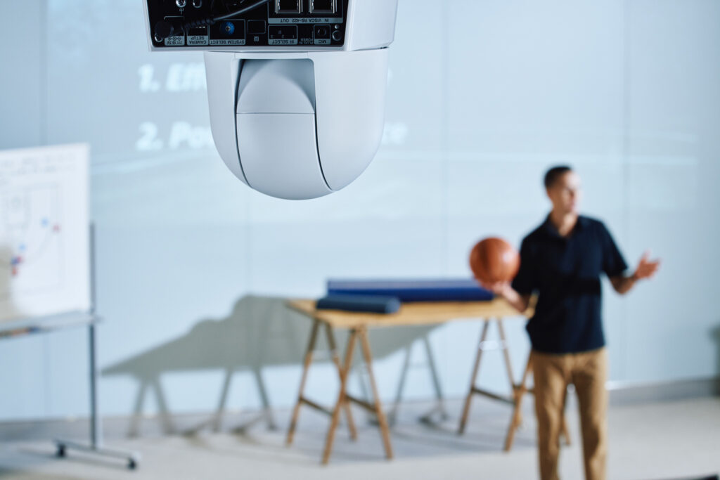 An AI-driven Sony PTZ camera records a professor giving a lecture.