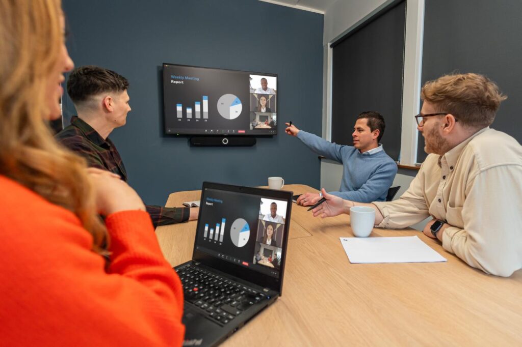 Team using a Sennheiser video bar to communicate during a hybrid meeting.