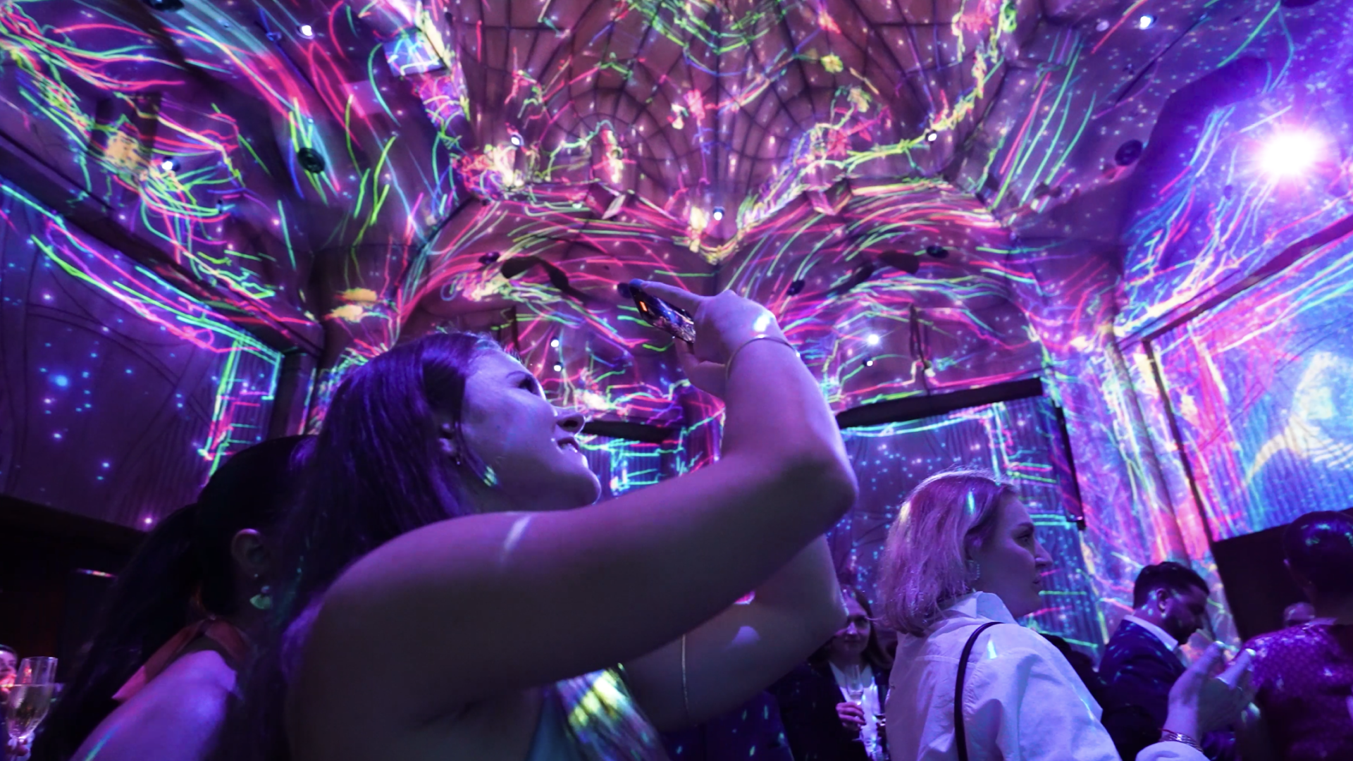 Lady records floor-to-ceiling projection mapping in the central Lost Chamber space.