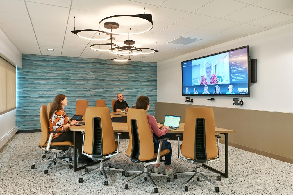 Team hosts a hybrid meeting using intelligent meeting technology.