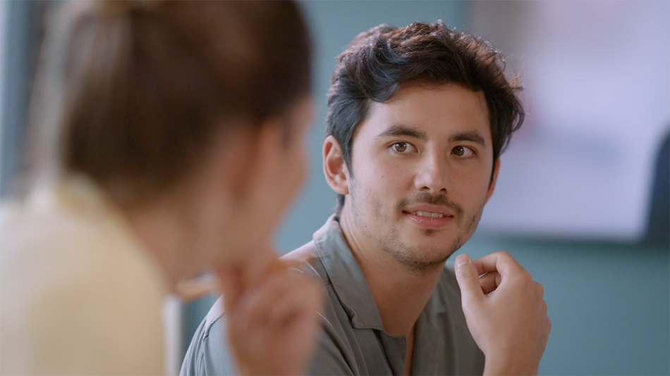 Close-up of two employees collaborating in a meeting room