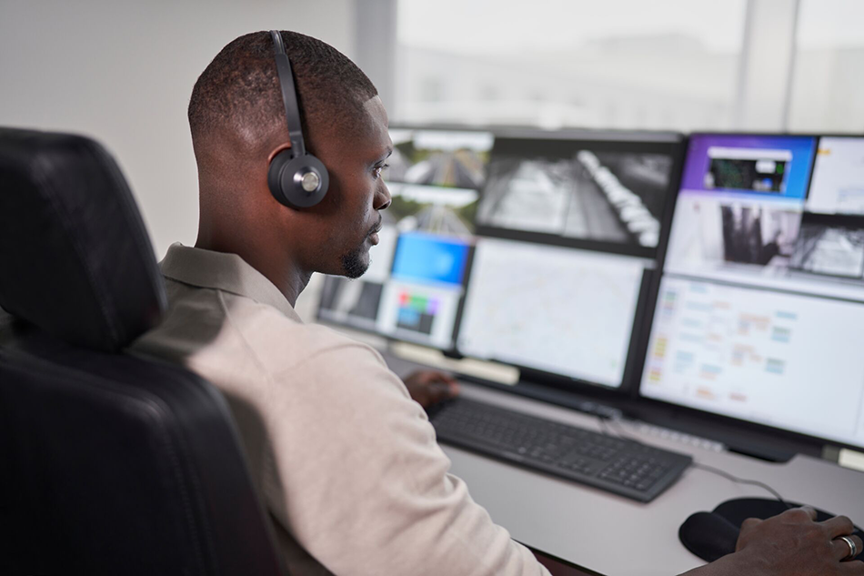 Barco command and control environment with an operator monitoring multiple displays.