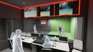 Broadcast control room viewing a small production studio with a green screen.