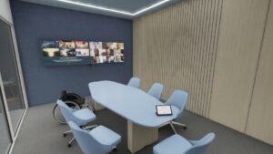 Small meeting space with two wall-mounted displays, a conference table, seating, and wheelchair.