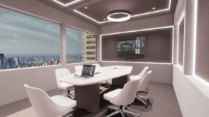 empty conference room with laptop on a table and a display on the back wall.