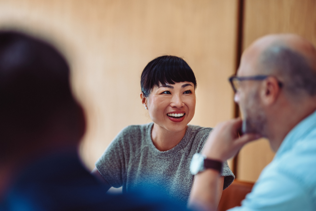 Close-up of a woman in a meeting, looking happy